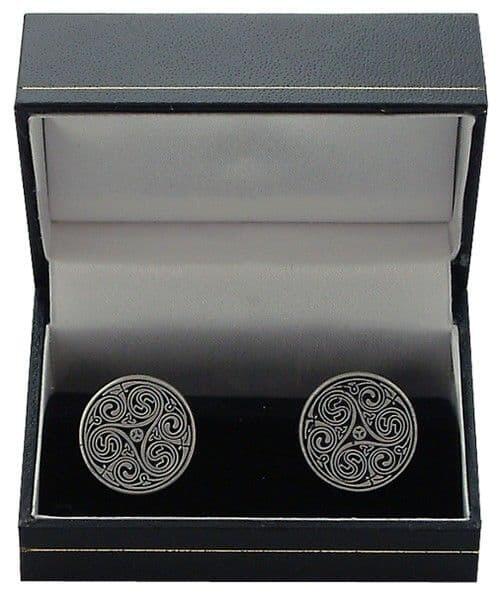 Silver cufflinks with intricate swirl design in a black gift box.