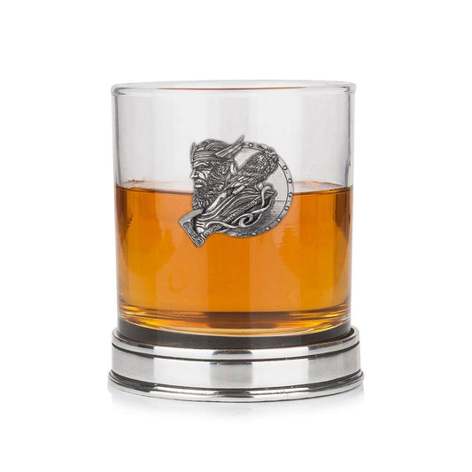 Whisky tumbler with pewter Viking motif and polished base, partially filled with amber liquid