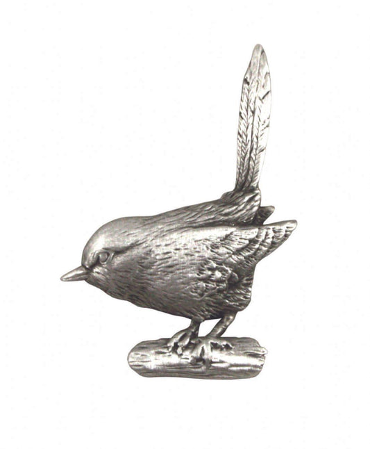 Silver metal bird figurine perched on a log with detailed feathers